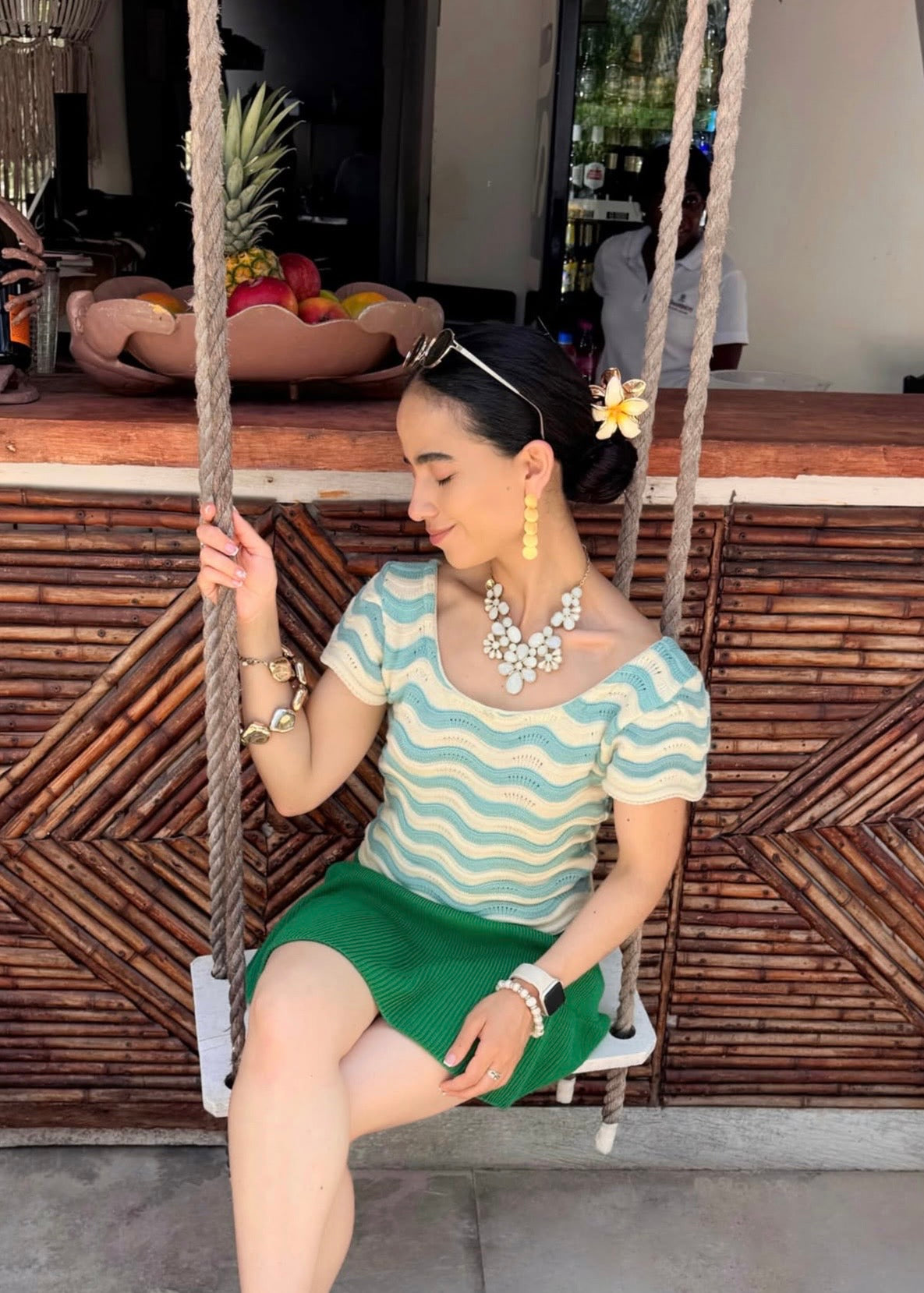 "Celeste Cielo", blusa tejida en tonalidad crema, con detalles asimétricos en celeste claro.